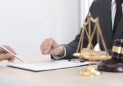 Legal Parentage - An image of a client discussing parentage with his lawyer and a gavel beside him - Ghazi Law Group